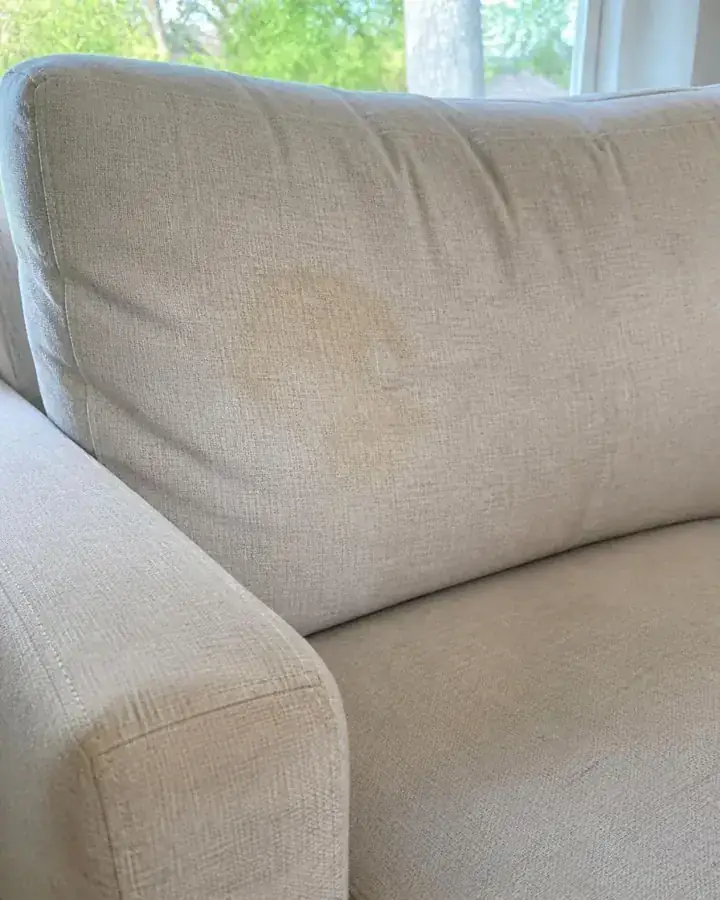 Cream sofa cushion before treatment, with a stain